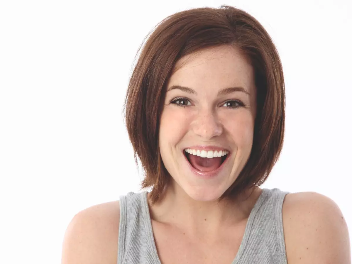 Woman laughing with a white background